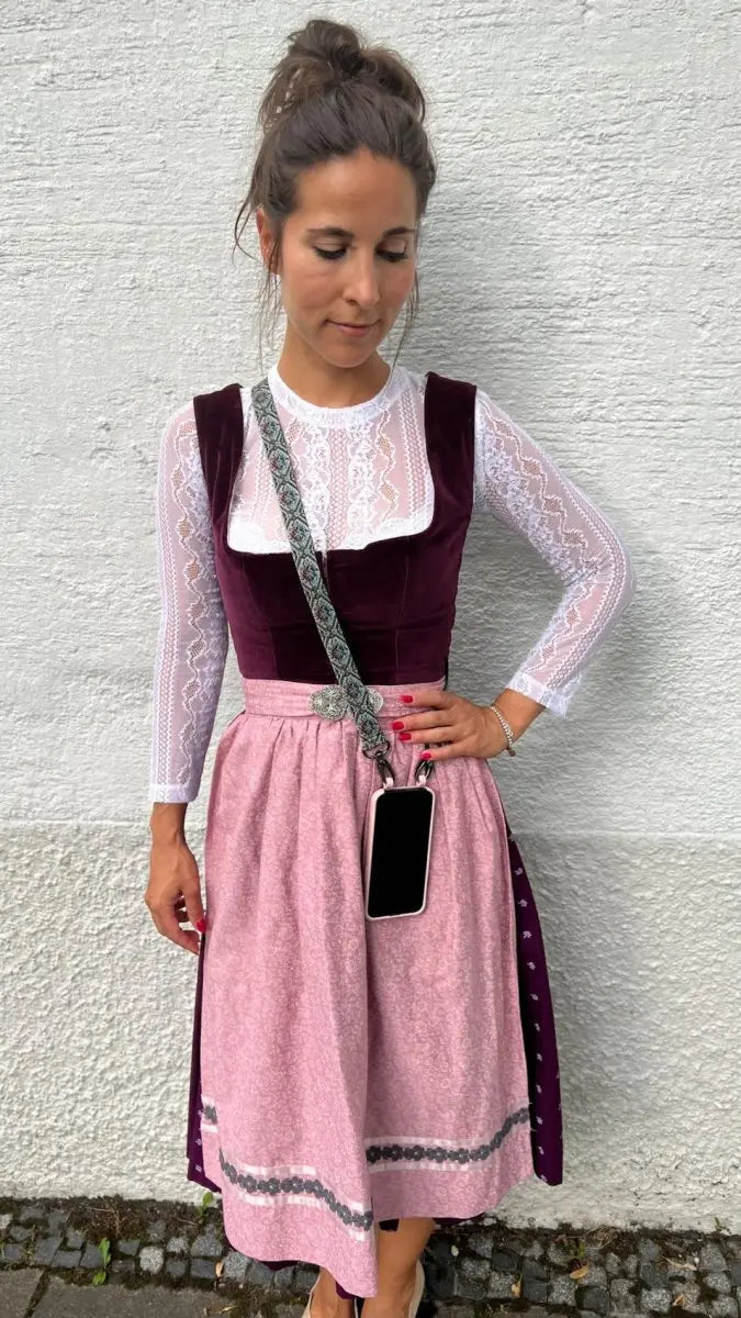 frau in dirndl mit handykette